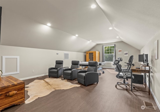 home theater with hardwood / wood-style floors and vaulted ceiling