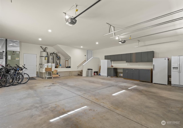 garage with white fridge with ice dispenser, white fridge, and a garage door opener