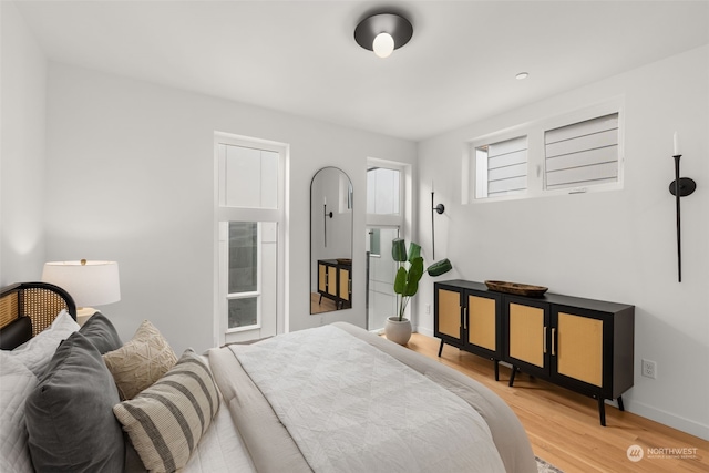 bedroom with hardwood / wood-style flooring