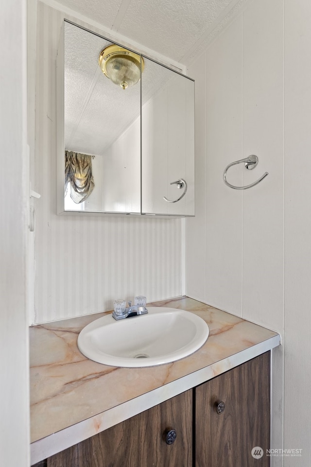 bathroom with vanity and a textured ceiling