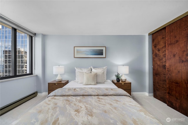 carpeted bedroom with a baseboard radiator