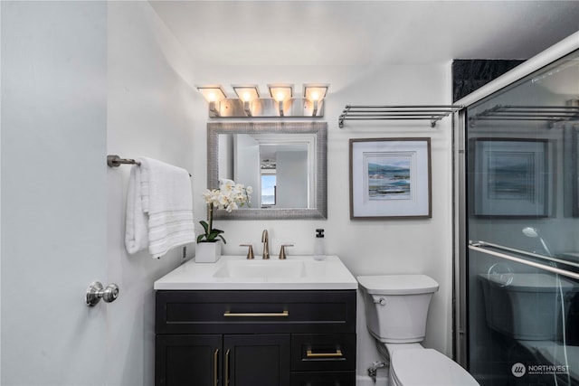 bathroom featuring vanity, an enclosed shower, and toilet