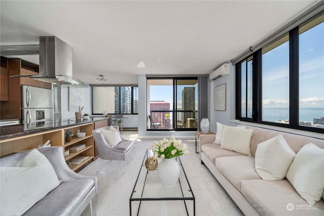 living room featuring an AC wall unit, expansive windows, and a water view