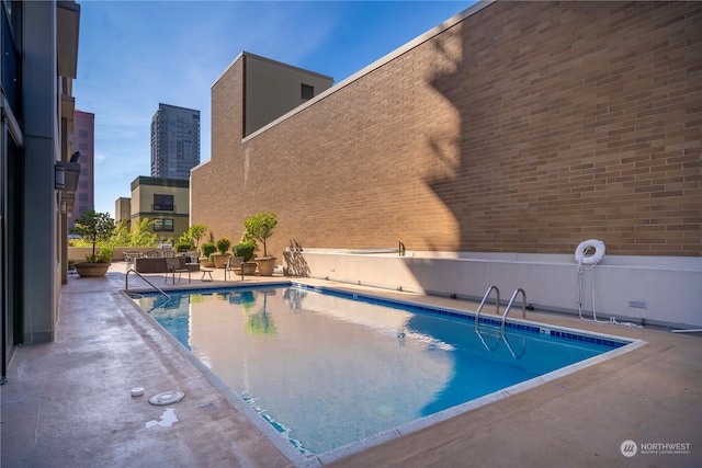 view of swimming pool with a patio area