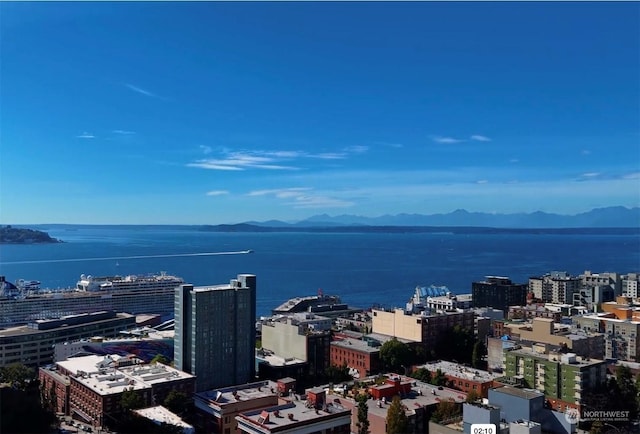 drone / aerial view with a water and mountain view