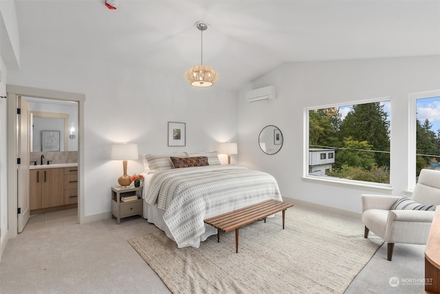 bedroom featuring ensuite bathroom, an AC wall unit, lofted ceiling, an inviting chandelier, and light colored carpet