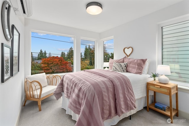 carpeted bedroom featuring a wall unit AC