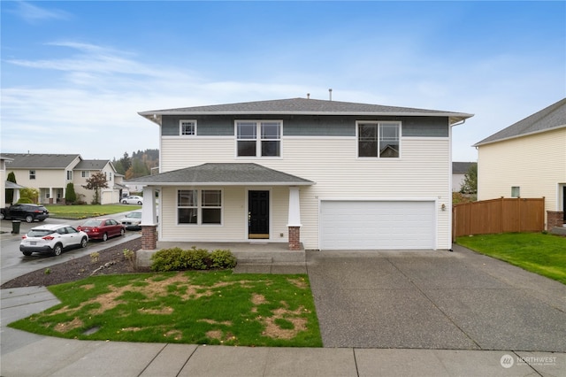 front of property with a front yard and a garage