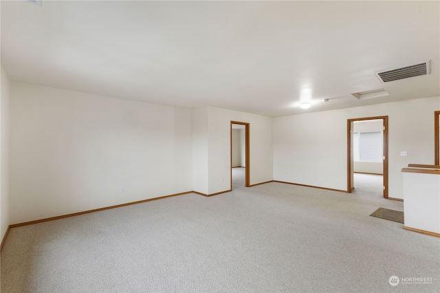 unfurnished room featuring light colored carpet