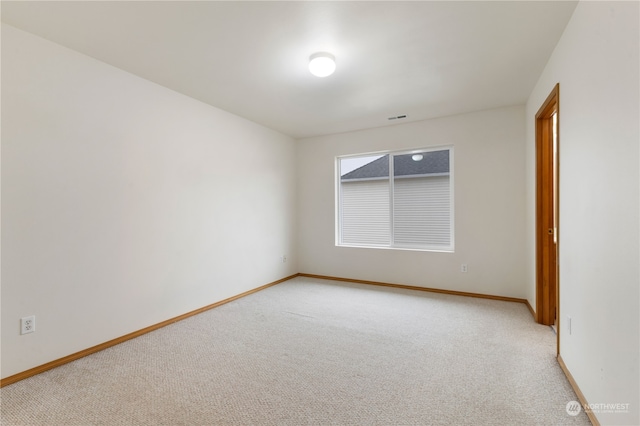 unfurnished room with light carpet