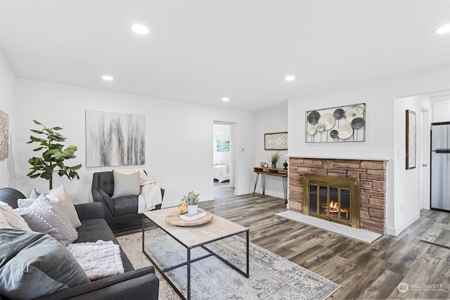 living room with a fireplace and dark hardwood / wood-style flooring