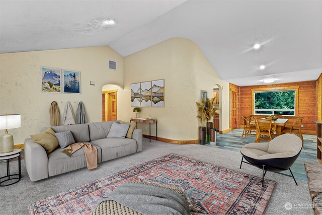 carpeted living room with vaulted ceiling