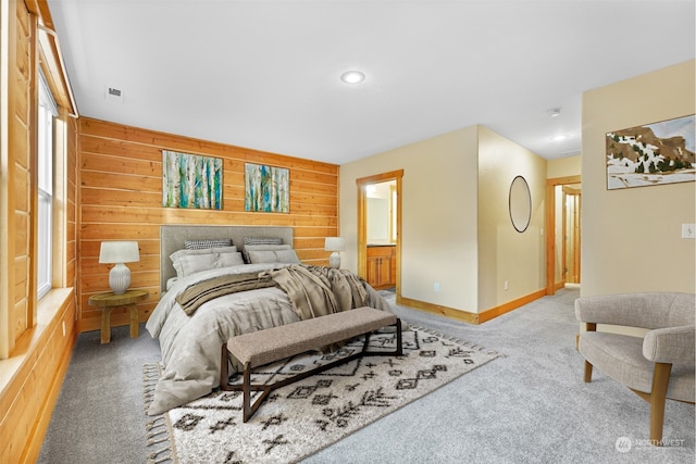 bedroom featuring wood walls and carpet