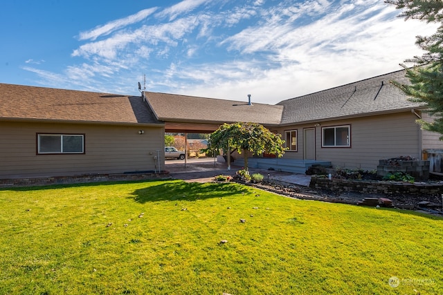 rear view of house with a patio and a yard