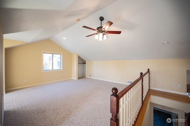 additional living space featuring ceiling fan, carpet, and vaulted ceiling