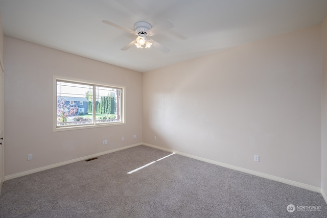 spare room with carpet and ceiling fan