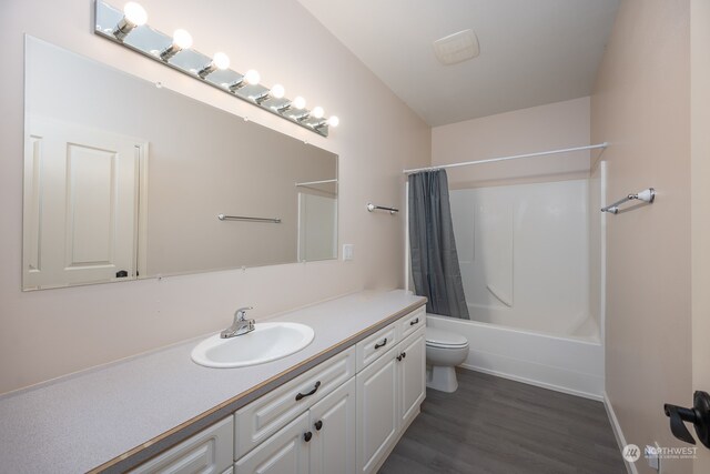 full bathroom featuring toilet, hardwood / wood-style flooring, vanity, and shower / tub combo