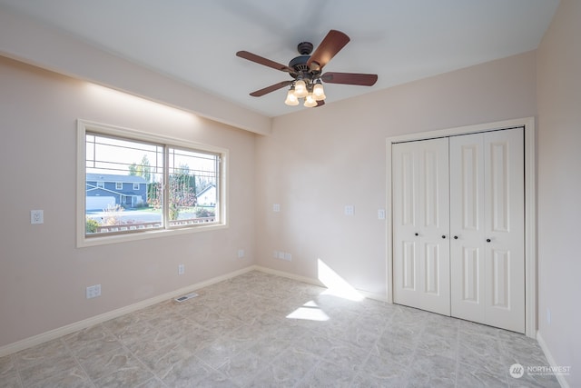 unfurnished bedroom featuring a closet and ceiling fan