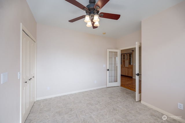 unfurnished bedroom featuring french doors, a closet, and ceiling fan