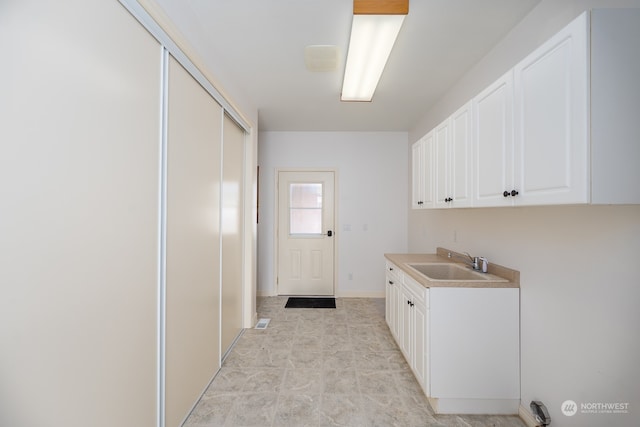 clothes washing area featuring sink