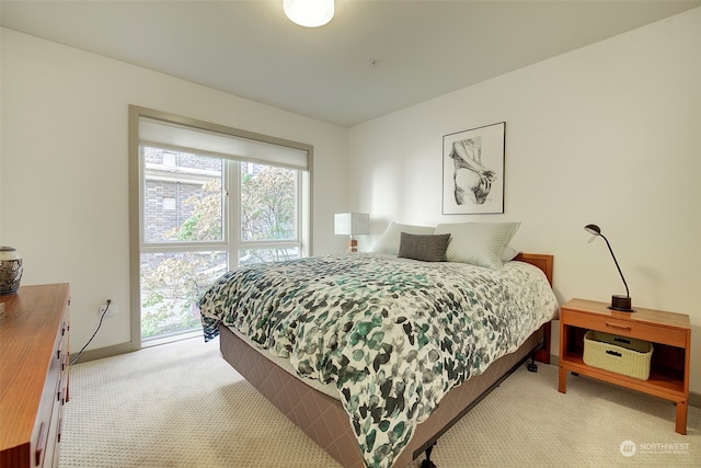 bedroom featuring light carpet