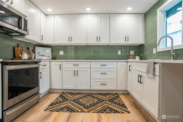 kitchen with white cabinetry and stainless steel appliances