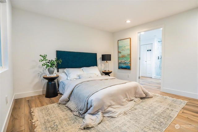 bedroom featuring wood-type flooring and ensuite bathroom