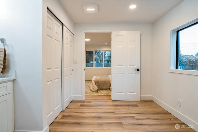 hall with light hardwood / wood-style floors