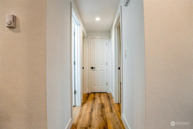 hallway with light wood-type flooring