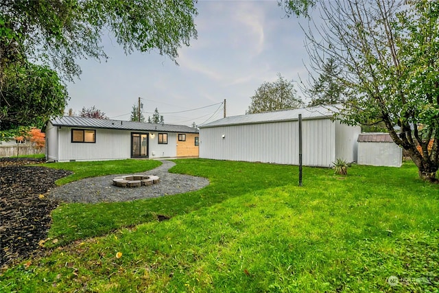 view of yard with an outdoor fire pit