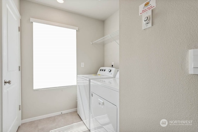 laundry room featuring laundry area, baseboards, and independent washer and dryer