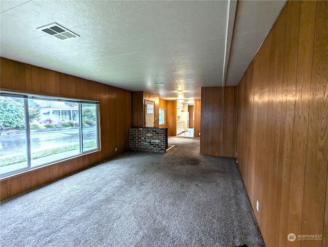 930 Trosper Rd SW Unit 70, Tumwater, WA 98512 - unfurnished living room featuring carpet and wooden walls