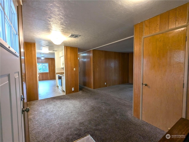 930 Trosper Rd SW Unit 70, Tumwater, WA 98512 - unfurnished room featuring carpet, wooden walls, and a textured ceiling