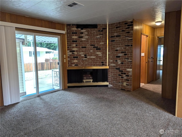 930 Trosper Rd SW Unit 70, Tumwater, WA 98512 - unfurnished living room featuring carpet floors, wood walls, and a fireplace