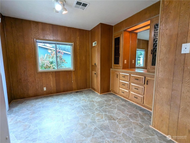 930 Trosper Rd SW Unit 70, Tumwater, WA 98512 - unfurnished bedroom featuring stone floors, wood walls, and baseboards