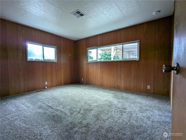 930 Trosper Rd SW Unit 70, Tumwater, WA 98512 - empty room featuring healthy amount of natural light, carpet flooring, and wood walls