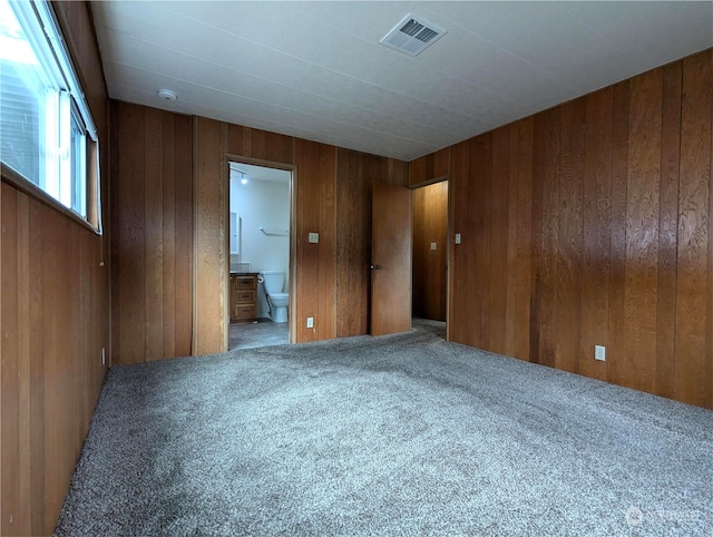 930 Trosper Rd SW Unit 70, Tumwater, WA 98512 - unfurnished bedroom with carpet floors, wood walls, and ensuite bathroom