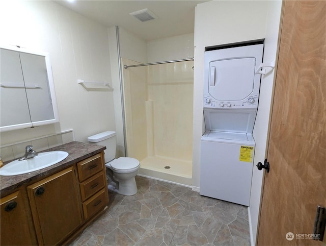 930 Trosper Rd SW Unit 70, Tumwater, WA 98512 - full bath with stacked washing machine and dryer, vanity, toilet, and a shower