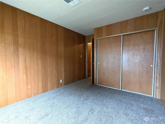 930 Trosper Rd SW Unit 70, Tumwater, WA 98512 - unfurnished bedroom with carpet flooring, wooden walls, and a closet