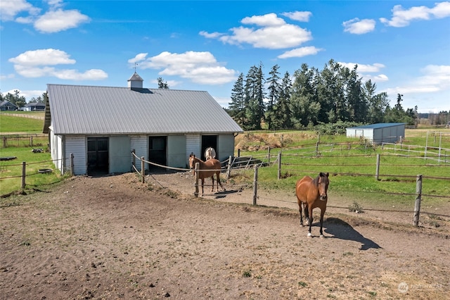 view of stable featuring a rural view