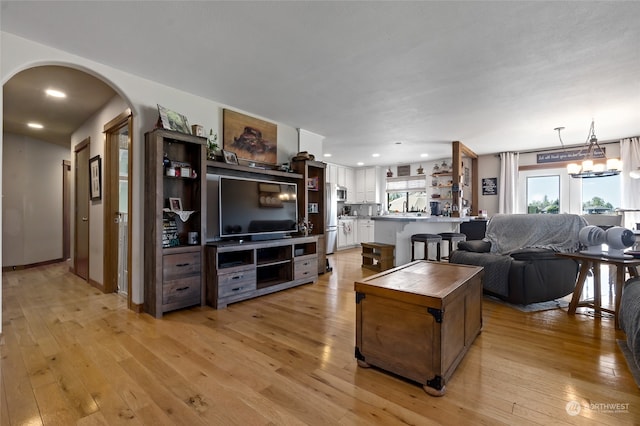 living room featuring light hardwood / wood-style flooring and a chandelier