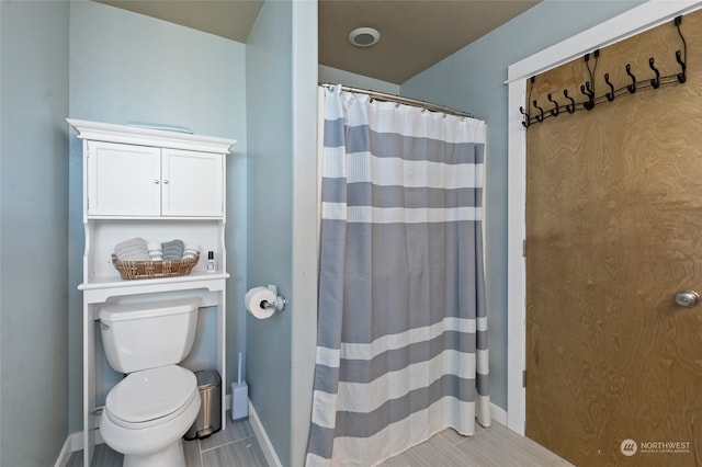 bathroom with toilet and walk in shower