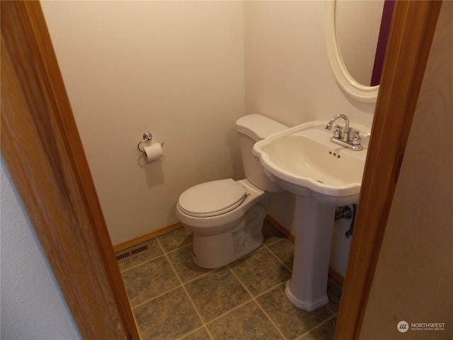 bathroom featuring sink, tile patterned floors, and toilet