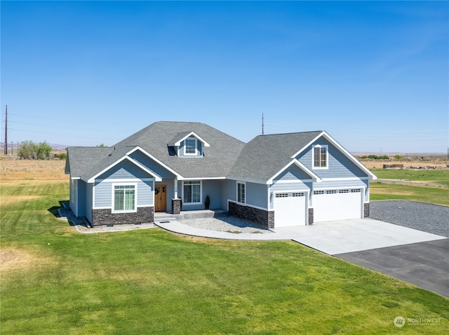 craftsman house with a front lawn and a garage