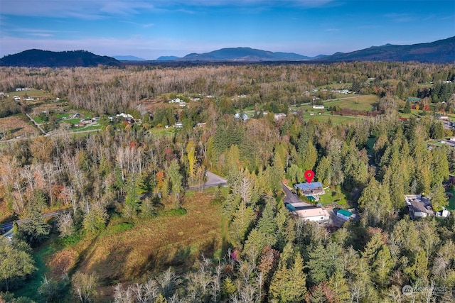 birds eye view of property with a mountain view and a forest view