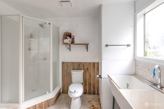 bathroom with toilet, sink, tile patterned flooring, and an enclosed shower