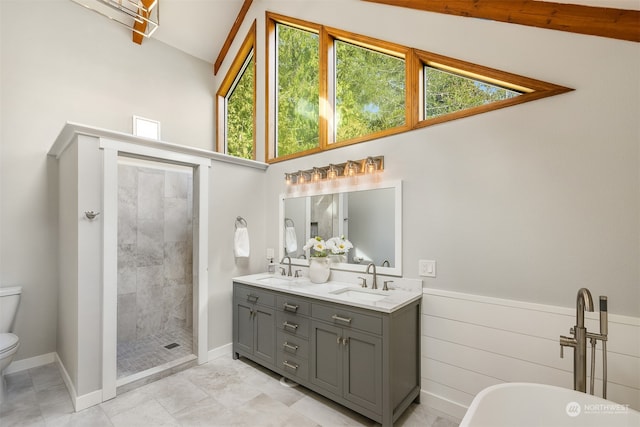 bathroom with lofted ceiling, a tile shower, toilet, vanity, and tile patterned floors