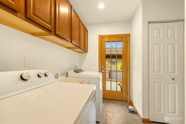 clothes washing area featuring separate washer and dryer, cabinet space, baseboards, and recessed lighting