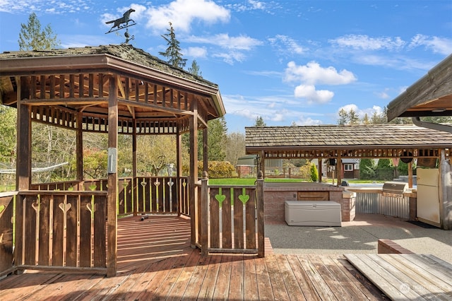 wooden deck with area for grilling, a gazebo, and a jacuzzi