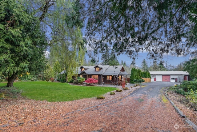 view of front of house with covered porch, a garage, and a front lawn